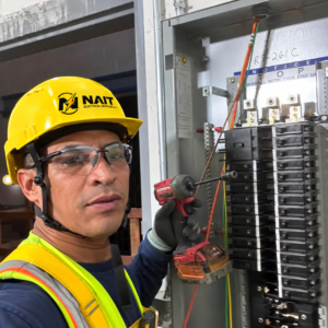 Electrician inspecting an electrical panel during a service project