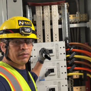 Electrician working on commercial electrical equipment